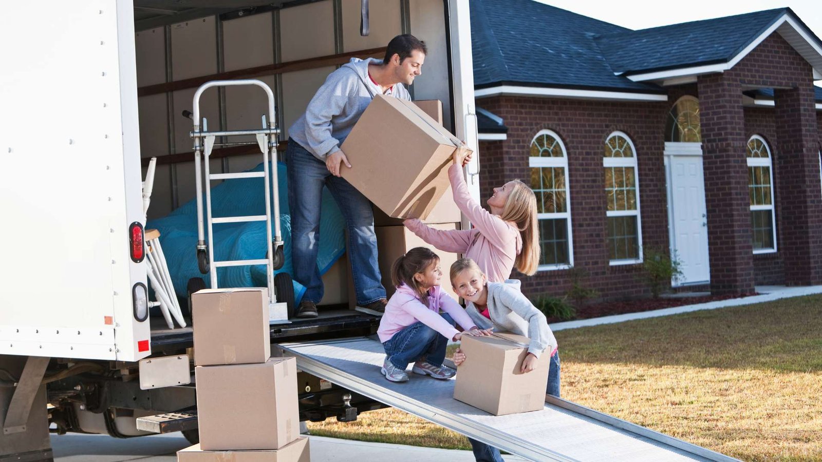 a man hand over a box from a truck to a woman